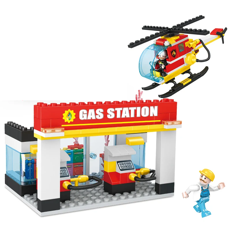 Bricks Box City set featuring a LEGO-style gas station and rescue helicopter with mini figures and accessories.